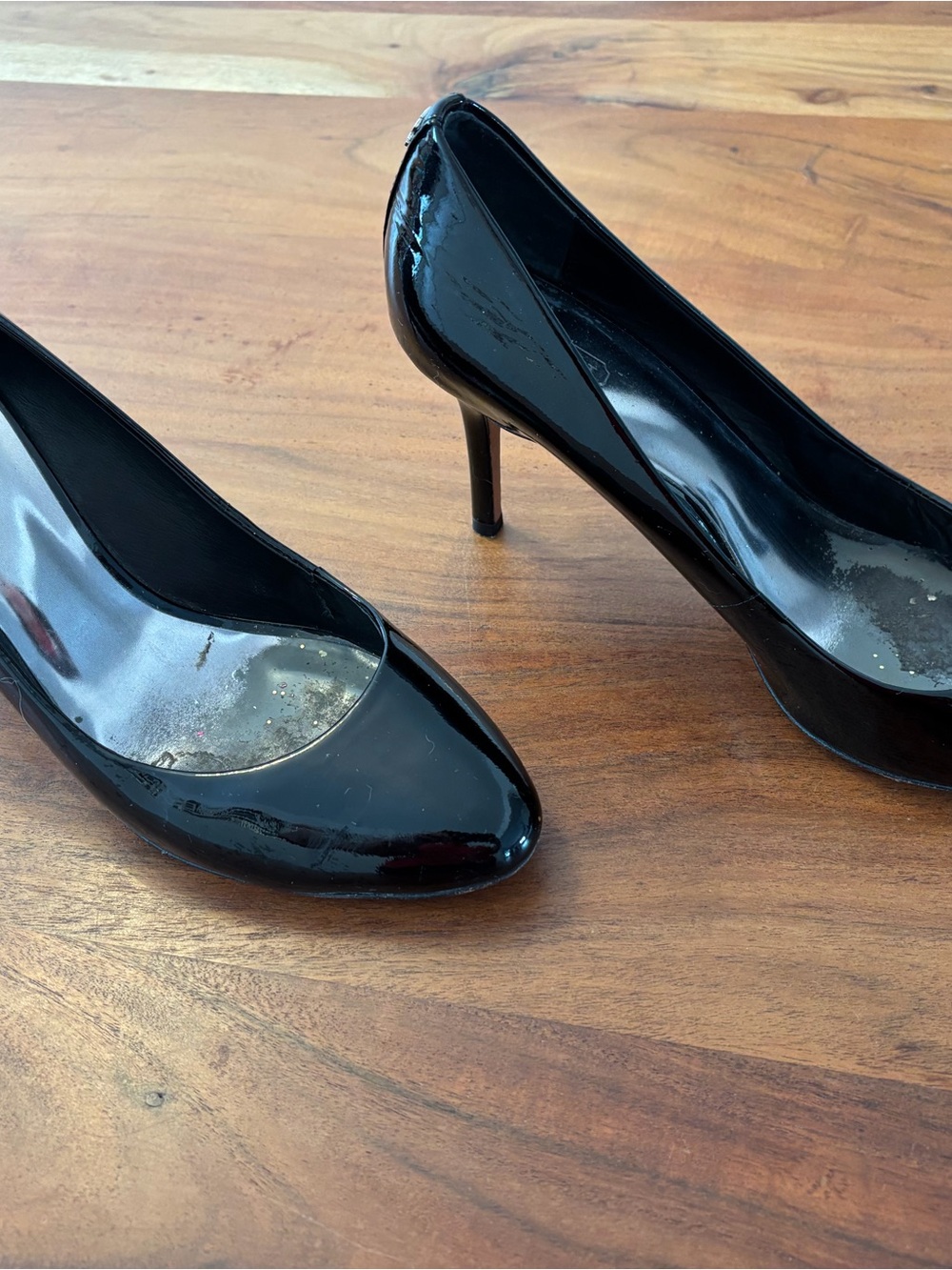 Coach women’s black patent leather heels with gold logo on the heel size 11